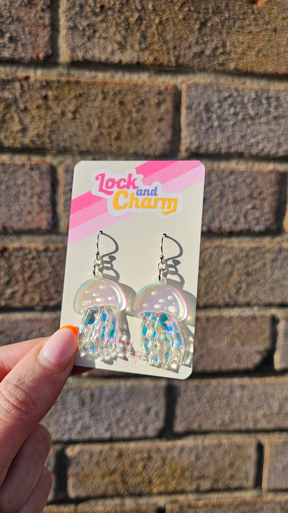 Earring packaging with a hand holding it against a textured wall background